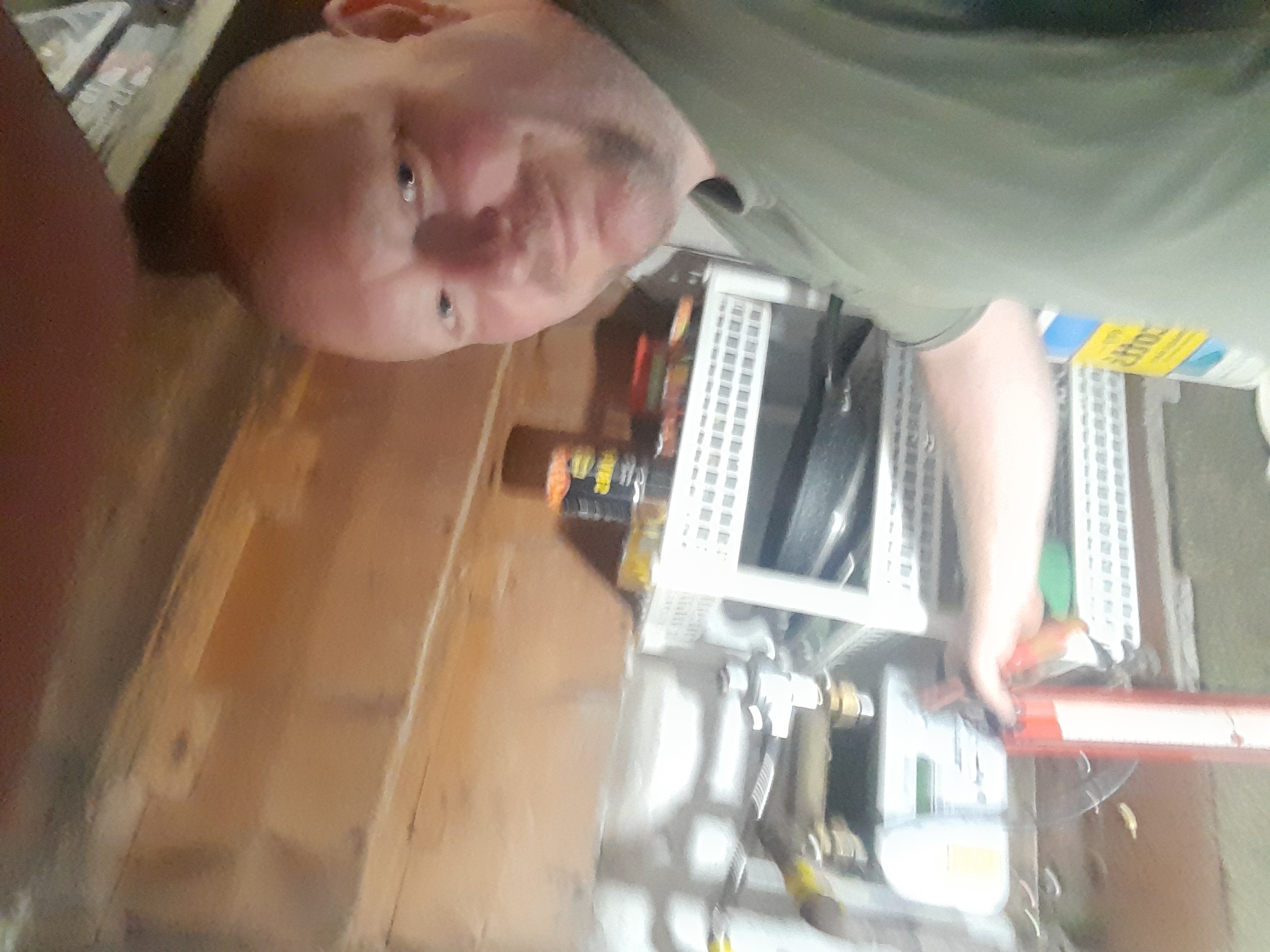 Andy Lander in his workshop, holding a pressure gauge