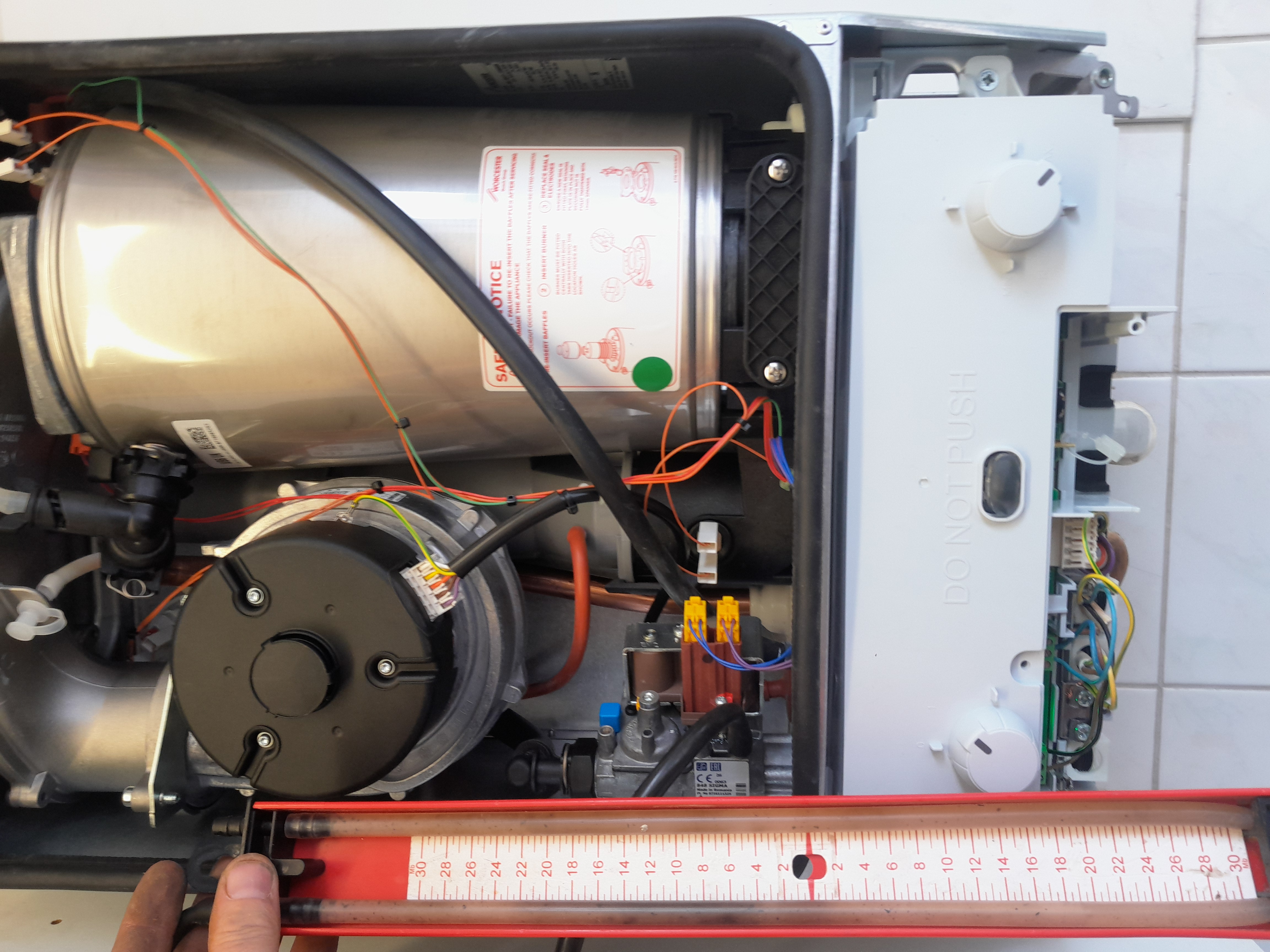 Boiler internals during installation, showing careful wiring and pipework