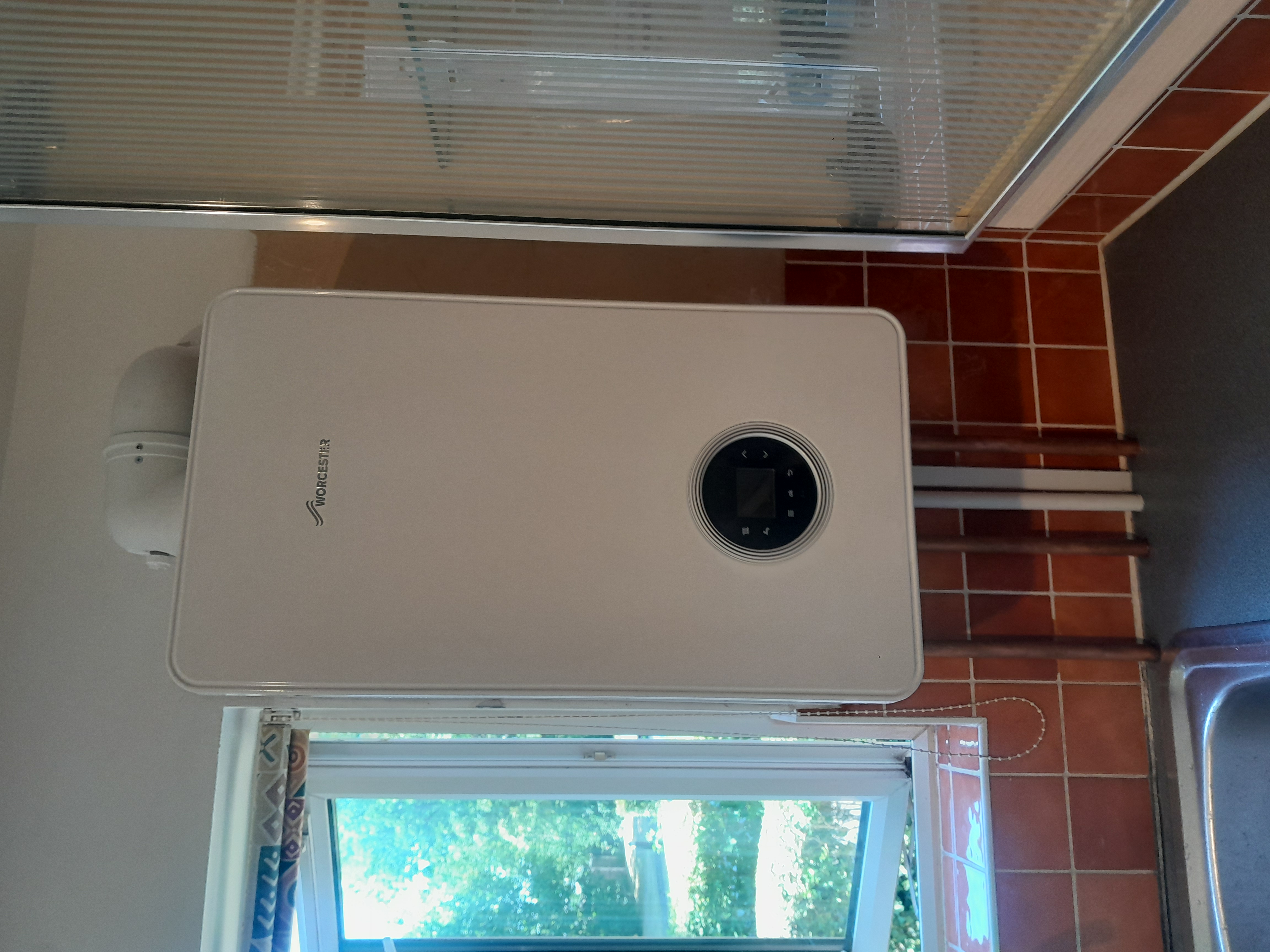 Newly installed Worcester Bosch combi boiler mounted in a Surbiton kitchen