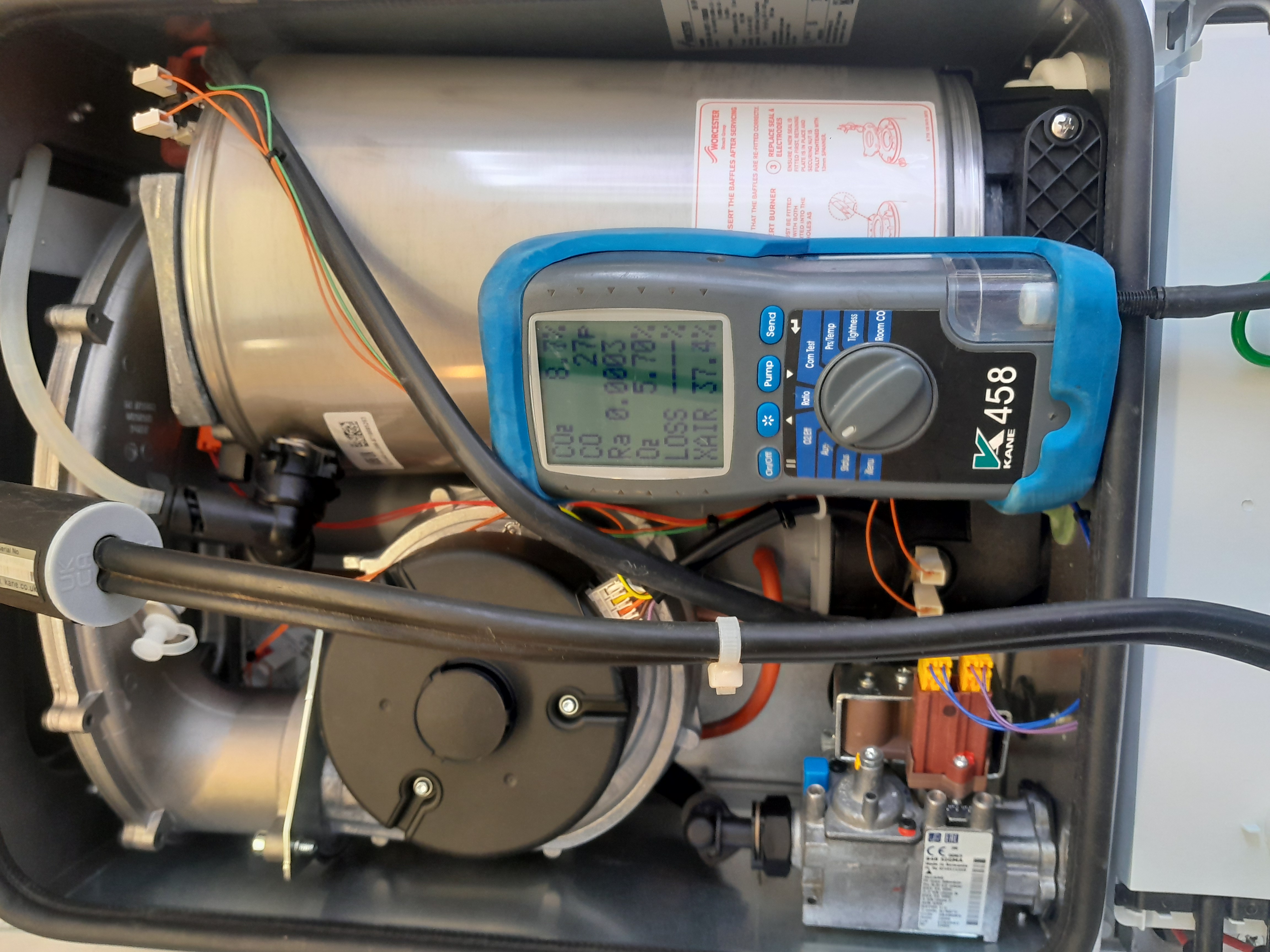 Flue gas analyzer connected to a boiler during a combined service and safety check