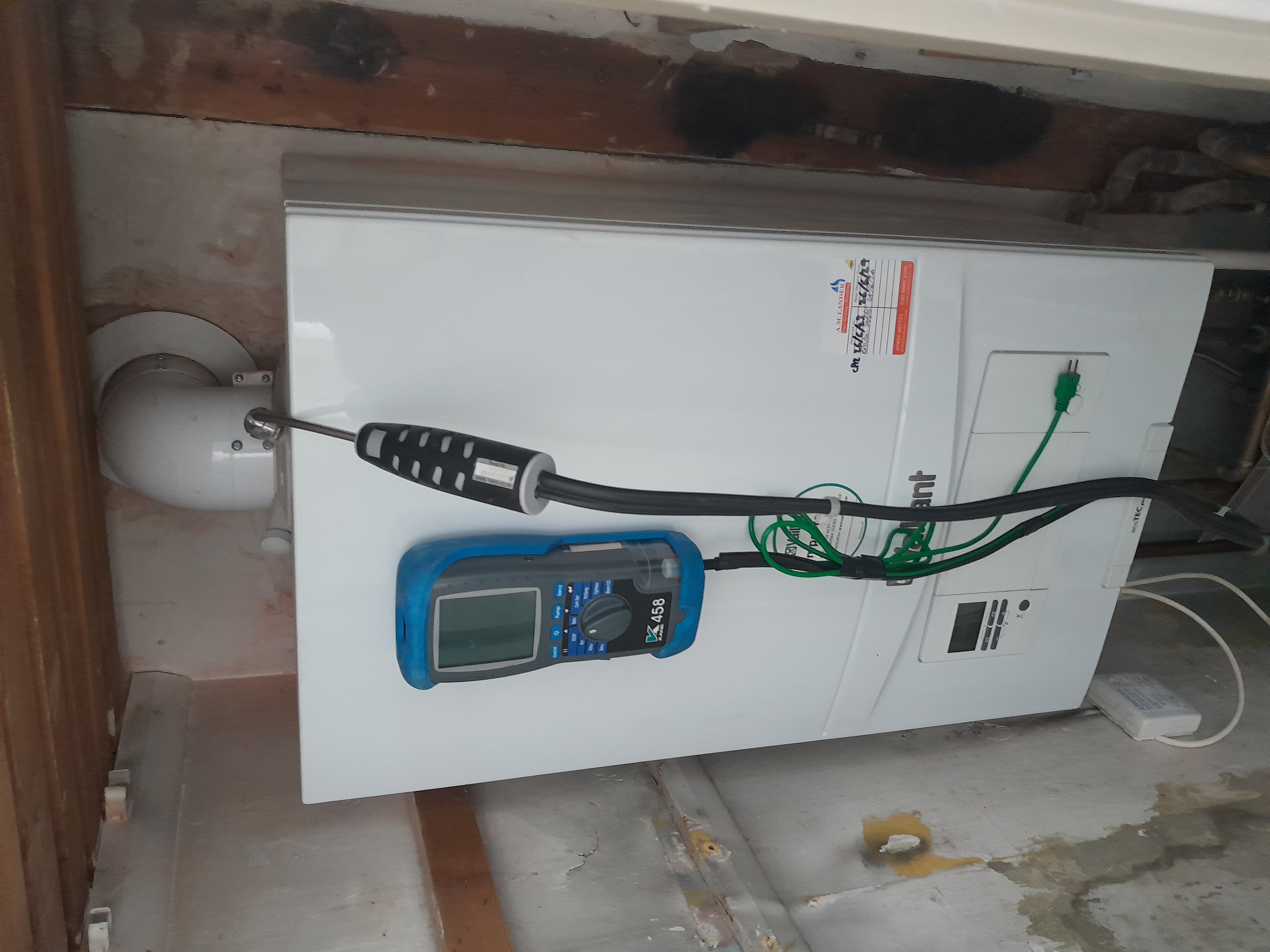 Flue gas analyzer attached to a boiler during a landlord gas safety inspection in Surbiton