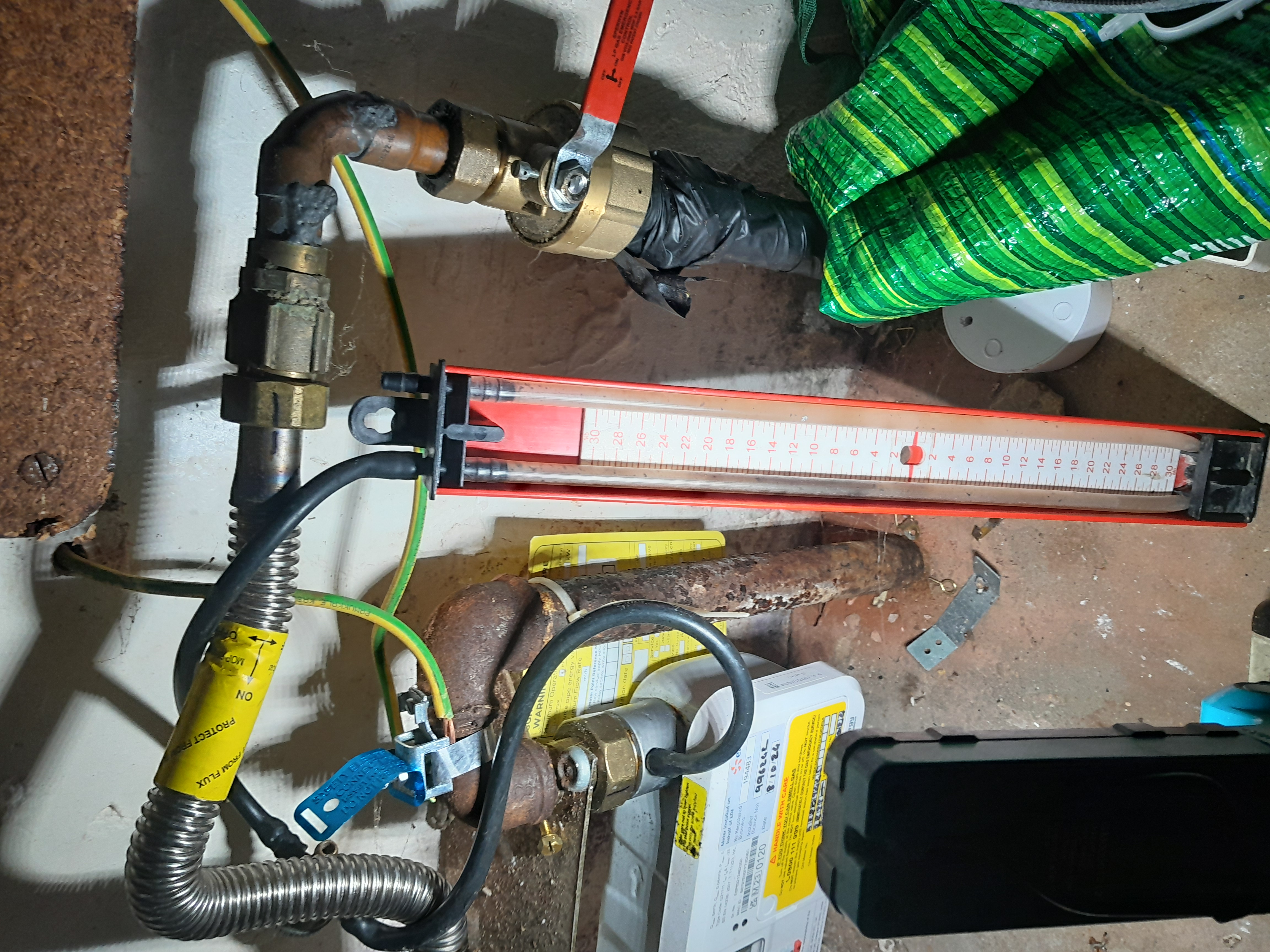 Flue gas analyzer attached to a boiler during a gas safety check in Wimbledon
