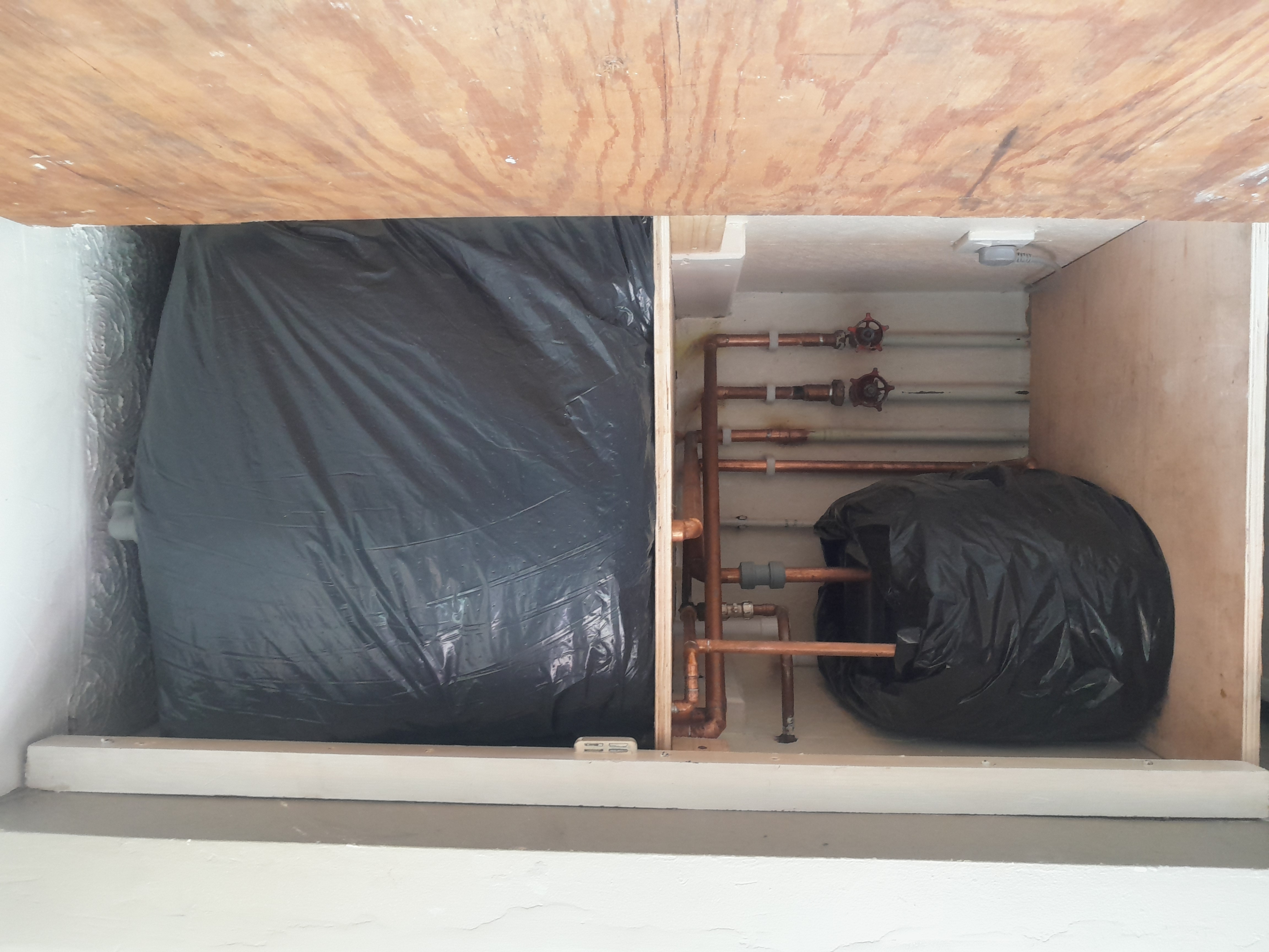 Unvented hot water cylinder installed in an airing cupboard, checked as part of a Legionella risk assessment